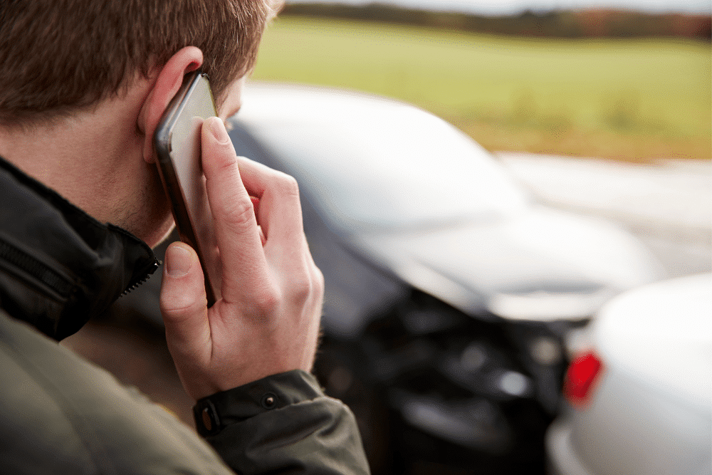 Man on phone after car accident