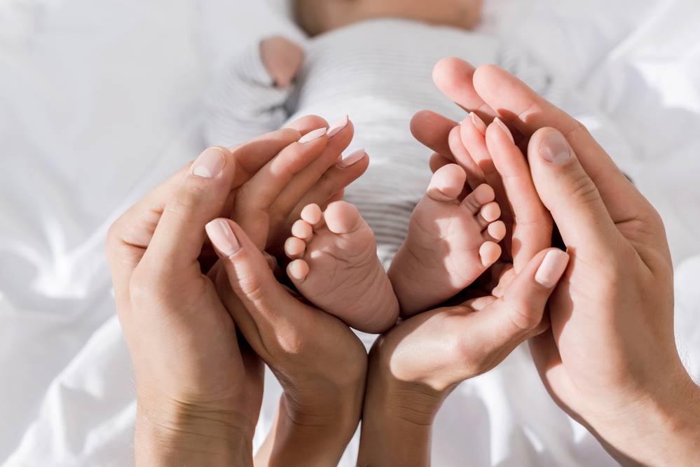 image of a baby and her parent's hands