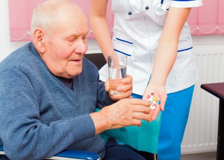 A senior taking his medications