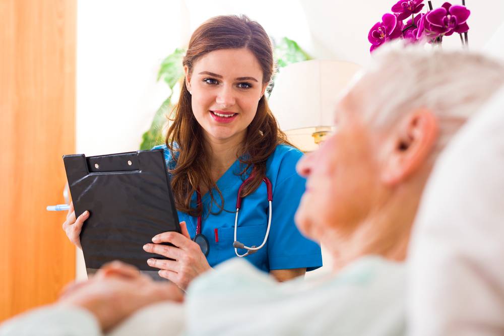 A nurse talking to a senior patient