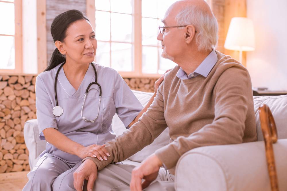 A nurse caring for a senior patient