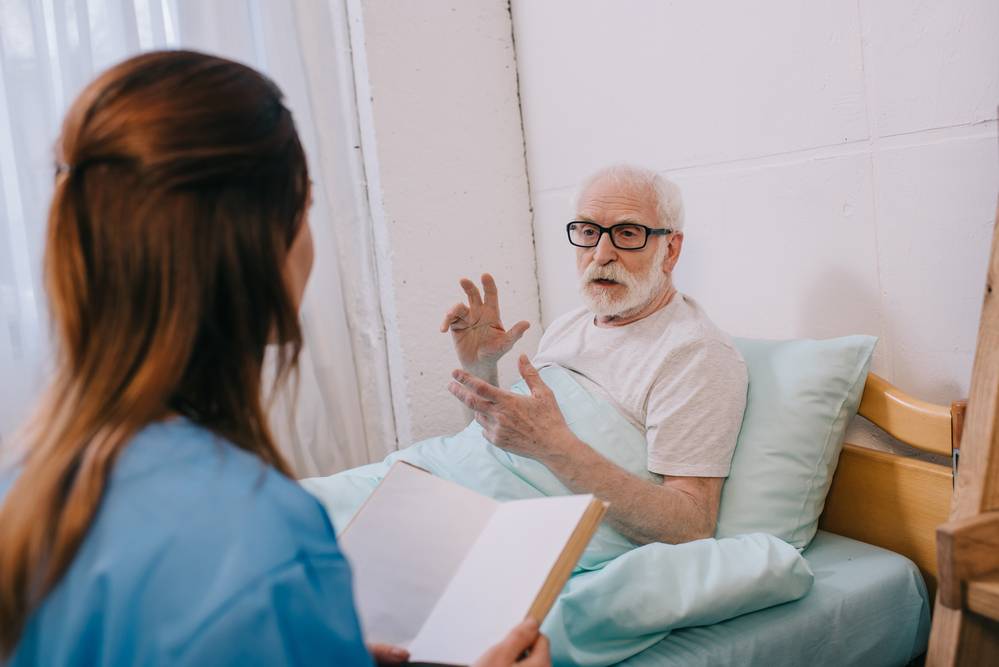 A senior talking to a nurse