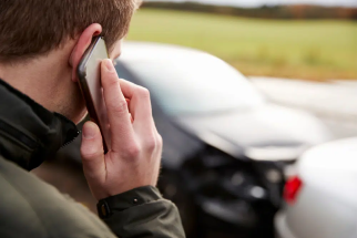 Man on phone after car accident