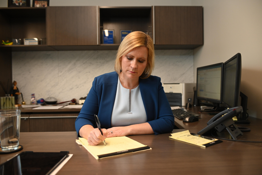 Margaret P. Battersby Black working at desk