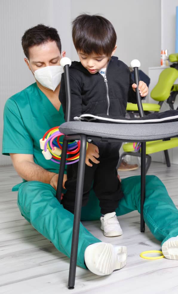 In the image, you see a child with cerebral palsy working with a doctor or therapist.