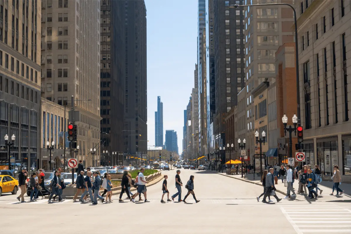 Busy Chicago street with pedestrians crossing and tall buildings