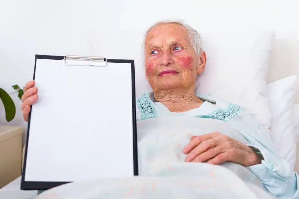 Female elder laying on bed.