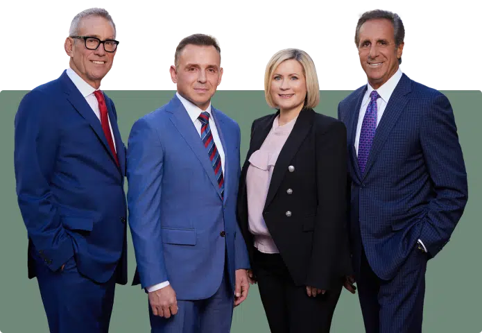 Managing partners at Chicago personal injury law firm. From left to right; Steve Levin, Michael Bonamarte, Margaret Battersby Black, and John Perconti standing side by side.