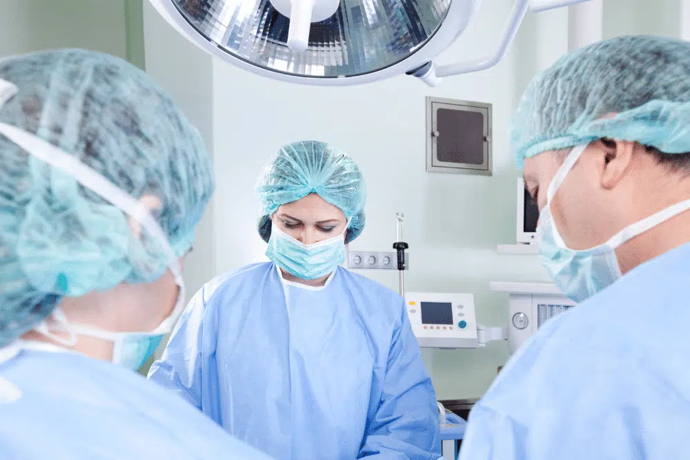 three medical professionals wearing surgical PPE