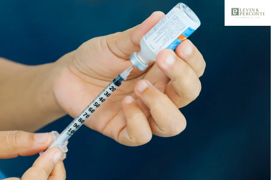 drawing insulin from a bottle with a syringe