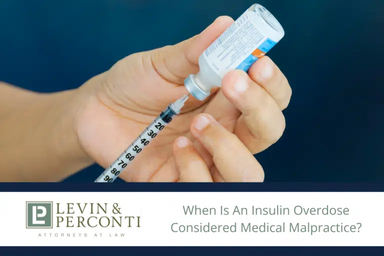 drawing insulin from a bottle with a syringe
