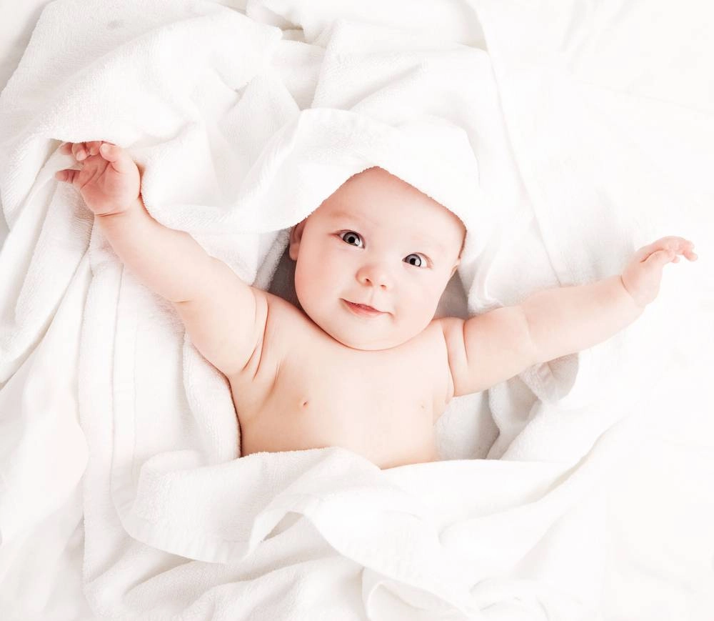 A baby wrapped in a towel