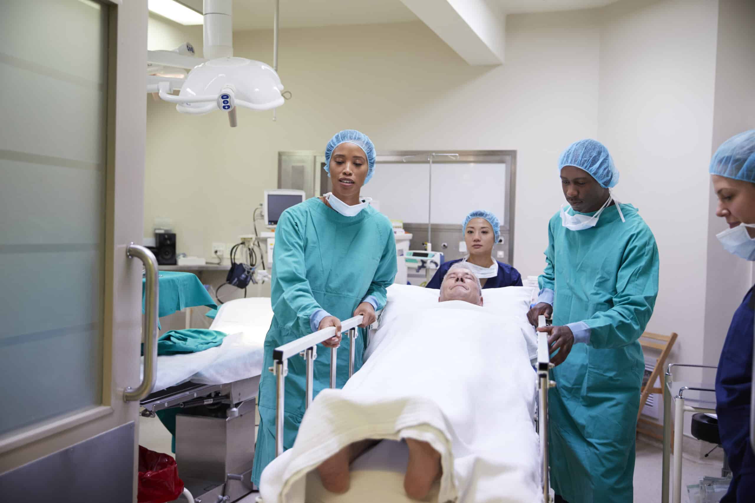 surgical team wheeling a patient out