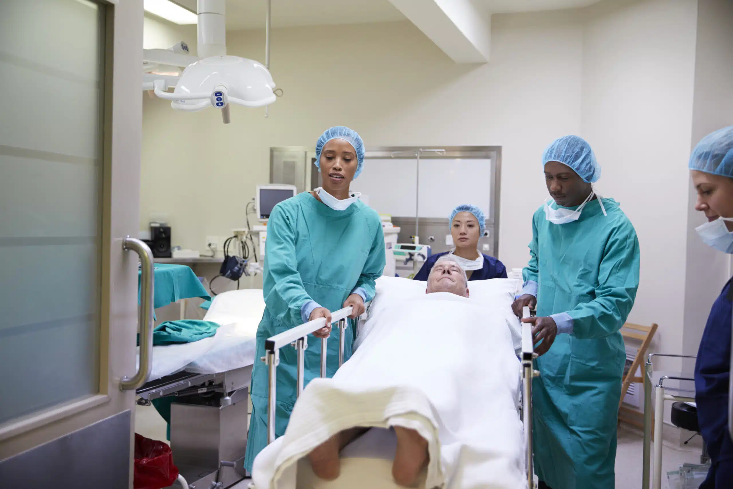 surgical team wheeling a patient out