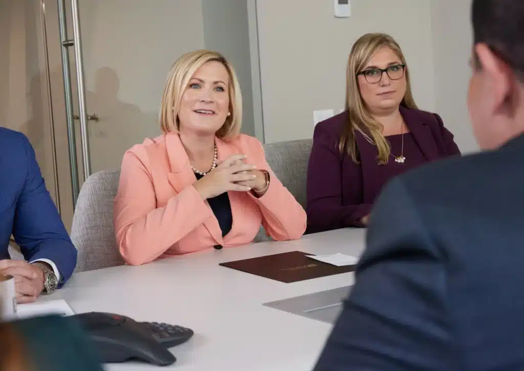 Margaret P Battersby Black sitting at a conference table meeting with other attorneys