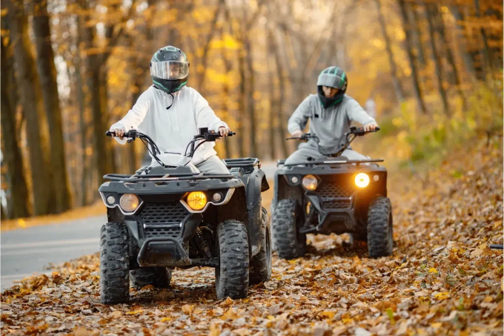 Image of two men driving ATVs