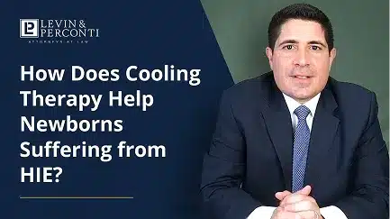 How does cooling therapy help newborns suffering from HIE