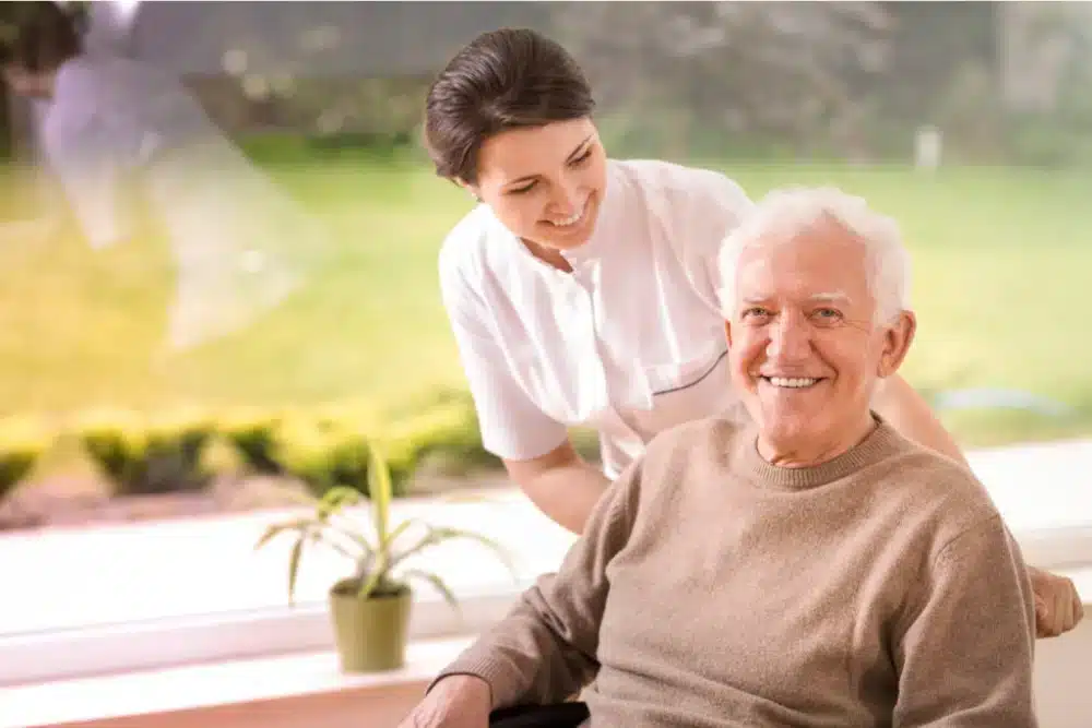 Nurse providing care to an older male patient