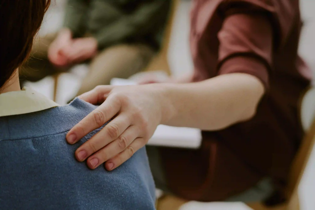 consoling-person-by-patting-on-shoulder-providing support