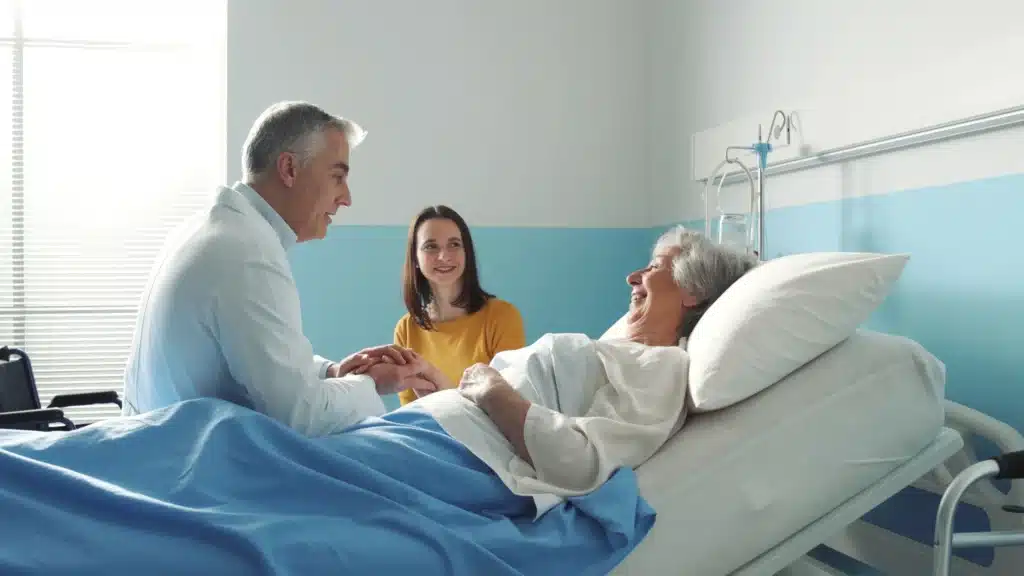 Family members visiting smiling elderly woman patient in hospital room