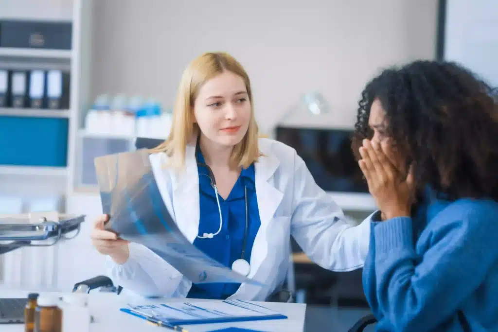 Doctor comforting a patient while discussing medical test results