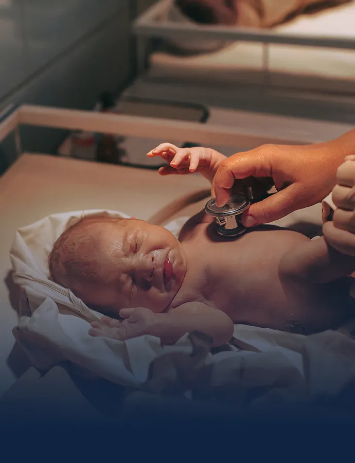 Newborn baby getting an exam from a nurse