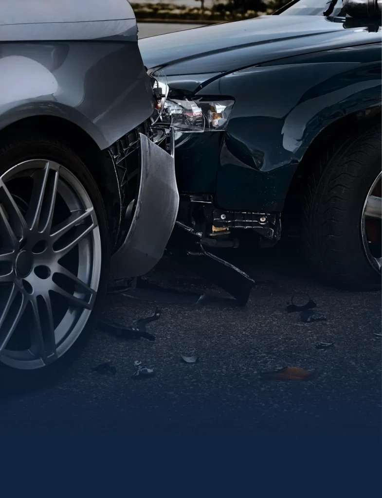 Close up view of the crumpled bumpers of two cars involved in collision