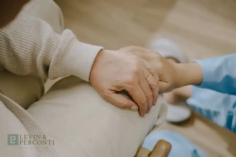 Family members holding hands in a nursing home