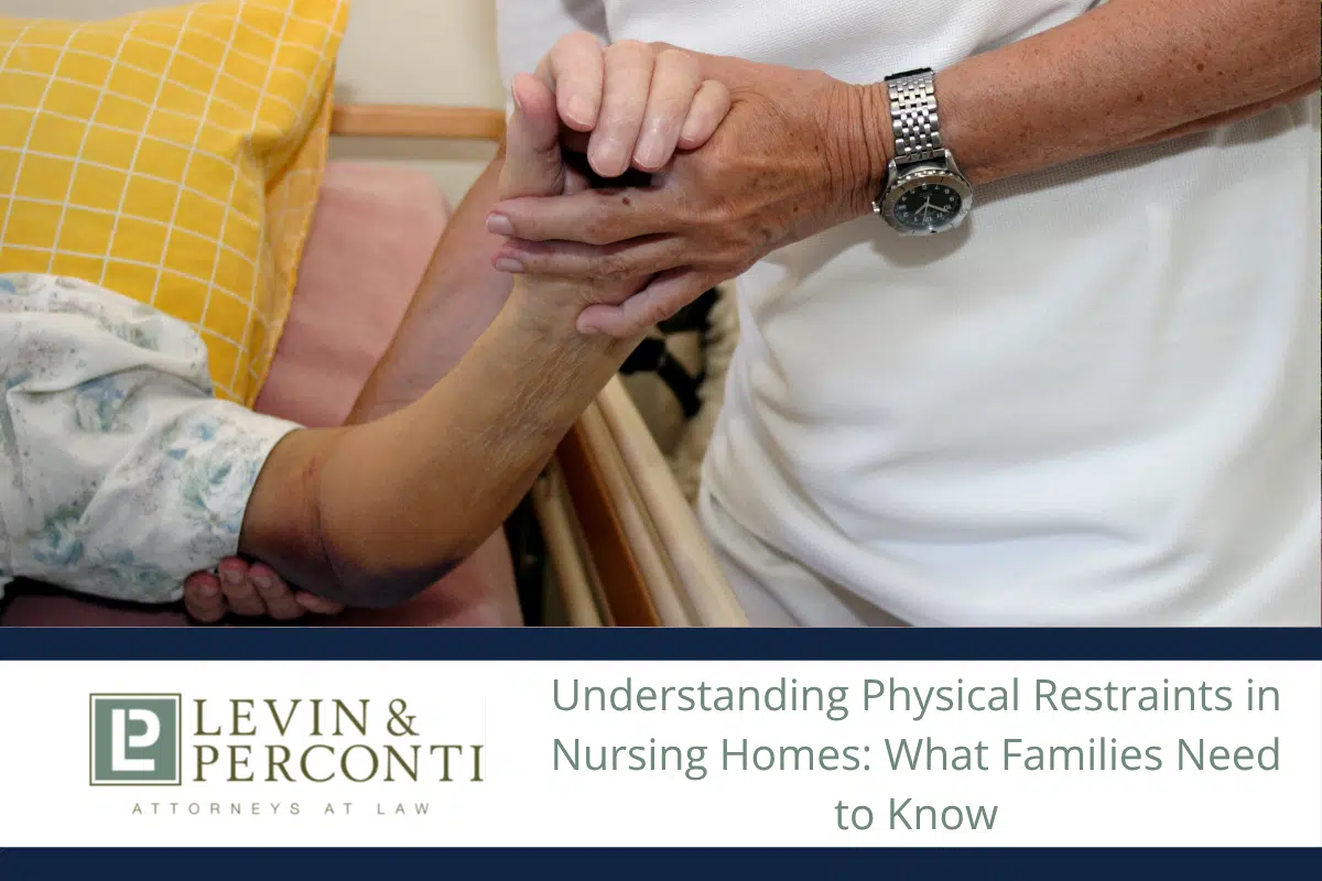 Man wearing a watch holding the arm of an elderly person with a bruised arm in a hospital bed