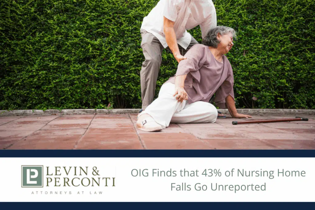 Elderly woman who has fallen on a patio being helped up by a man