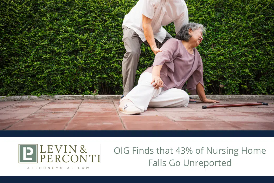 Elderly woman who has fallen on a patio being helped up by a man