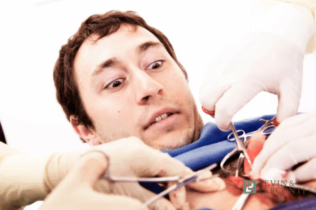 A patient appearing alarmed while awake during a surgical procedure, representing cases where someone wakes up during surgery