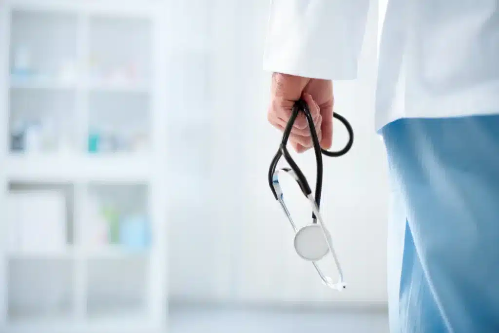 A doctor holding stethoscope in an hospital