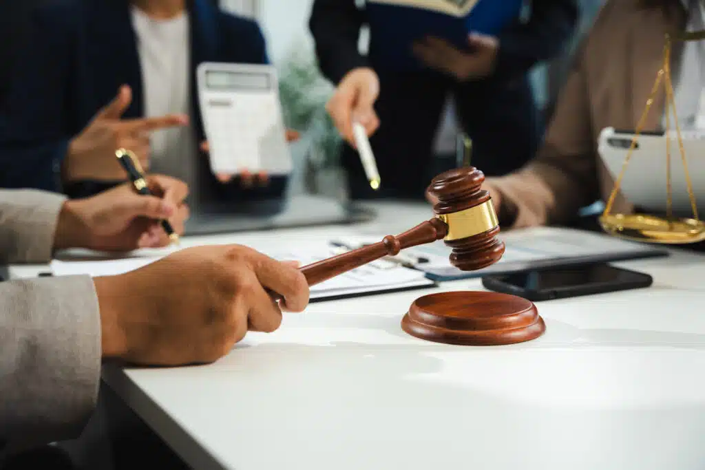 judge discussing law with other lawyers holding a gavel in hand