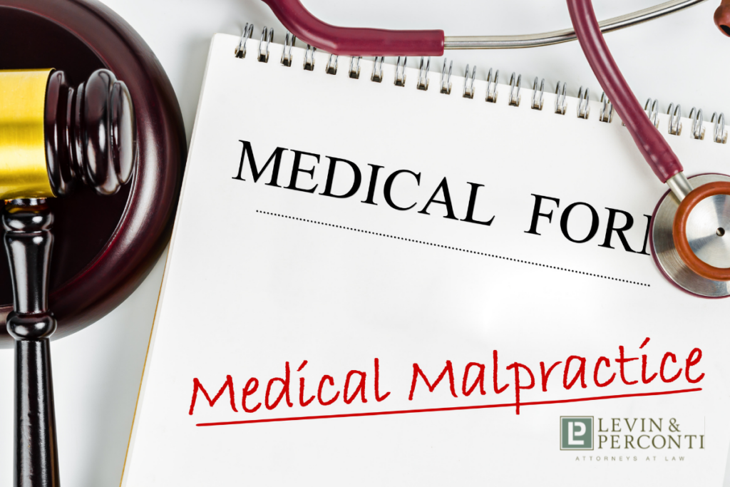 Medical form "medical malpractice" with gavel and stethoscope on the table