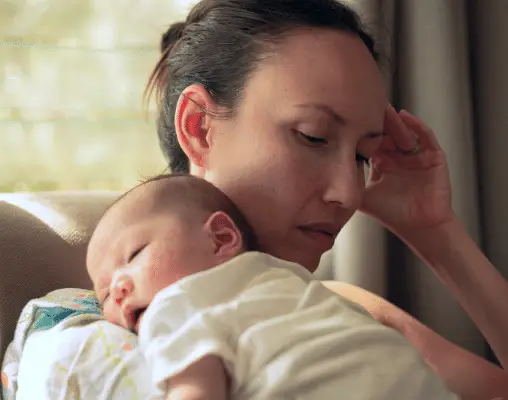 mother carrying a baby on her shoulder