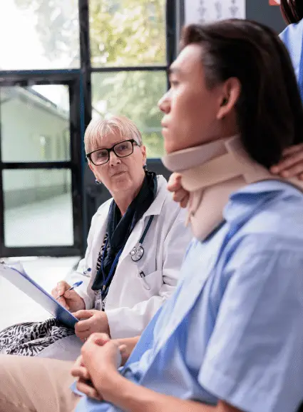 Doctor with stethoscope consulting with patient wearing neck brace