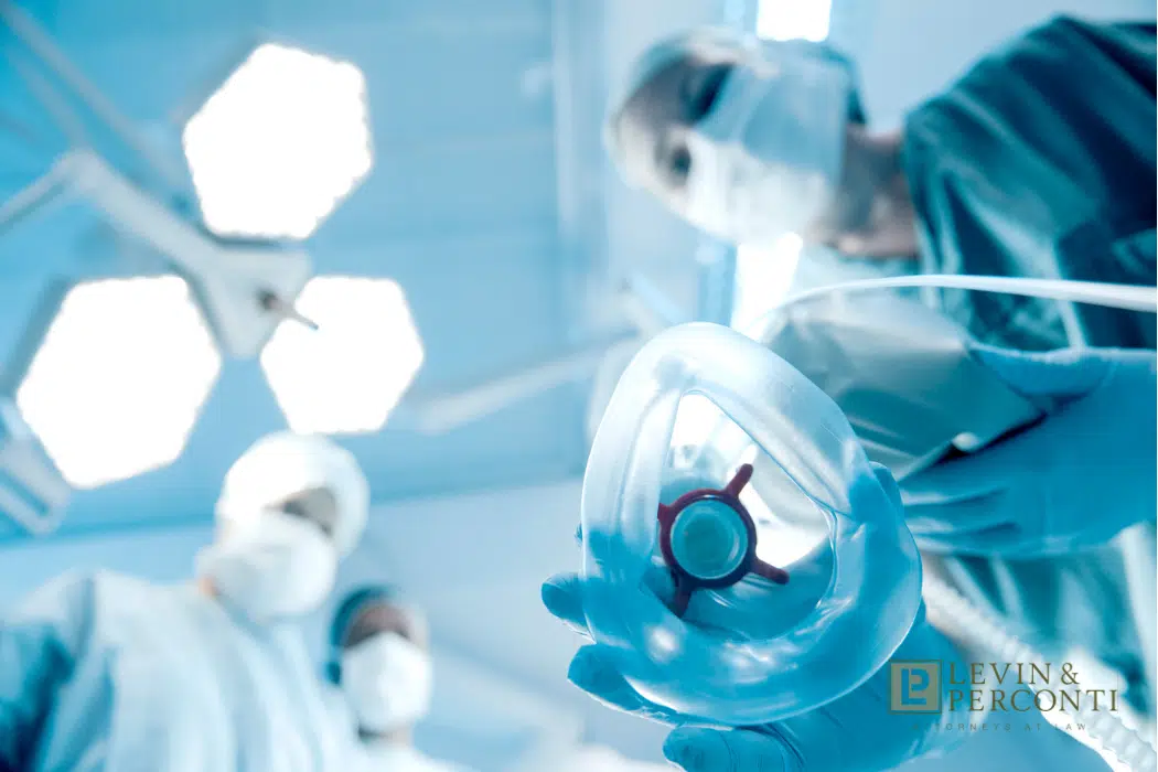 Anesthesia nurse putting a ventilator on a patient