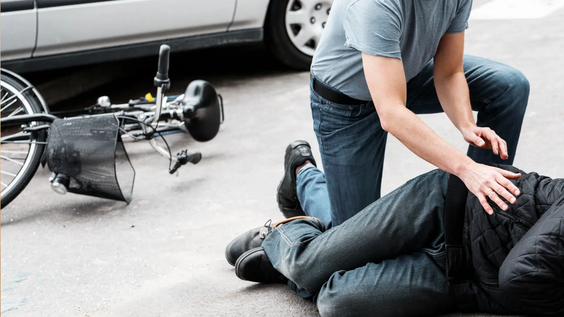 injured cyclist receiving help after a roadway accident