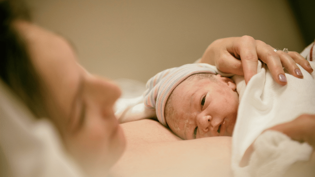 a mother laying with her daughter after giving birth