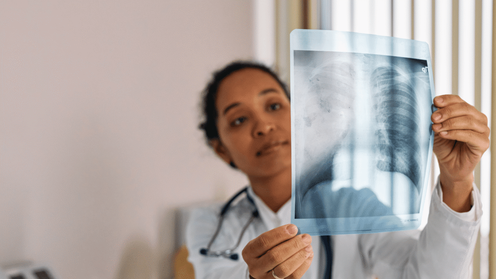 a radiologist checking an X-ray for lung cancer