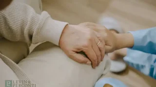 Family members holding hands in a nursing home
